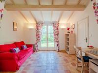 a living room with a red couch and a table at Holiday Home La Bastide Rose by Interhome in Sainte-Maxime