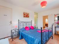 a bedroom with a blue bed with pink pillows at Holiday Home La Bastide Rose by Interhome in Sainte-Maxime
