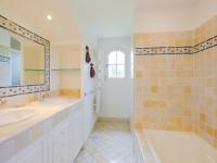 a bathroom with two sinks and a mirror and a shower at Holiday Home La Bastide Rose by Interhome in Sainte-Maxime