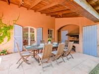 a dining room with a table and chairs on a patio at Holiday Home La Bastide Rose by Interhome in Sainte-Maxime