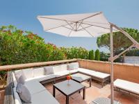 a patio with white furniture and an umbrella at Holiday Home La Bastide Rose by Interhome in Sainte-Maxime