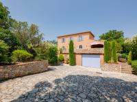 a house with a garage and a stone driveway at Holiday Home La Bastide Rose by Interhome in Sainte-Maxime