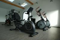 a gym with several exercise bikes in a room at Hotel Eskualduna Chez Katina in Saint-Martin-dʼArrossa