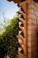 a bunch of wine bottles on the side of a wall at Apartman Fachin in Motovun