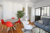 a living room with a couch and a table and chairs at Charming and luminous 2br with balcony - Boulogne-Billancourt - Welkeys in Boulogne-Billancourt