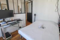 a bedroom with a bed and a desk with a computer at Charming and luminous 2br with balcony - Boulogne-Billancourt - Welkeys in Boulogne-Billancourt