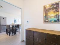 a dining room with a table and a picture on the wall at Apartment Rivadour 2 by Interhome in Bayonne
