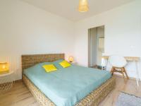 a bedroom with a large bed with yellow pillows at Apartment Rivadour 2 by Interhome in Bayonne