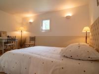 a bedroom with a large white bed with a window at Holiday Home La Bastide by Interhome in Tourves
