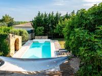 a swimming pool with a hammock in a garden at Holiday Home Le Mas d&#39;Adélaïs by Interhome in Baron