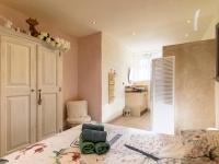 a bedroom with a bed and a bathroom at Holiday Home Le Mas d&#39;Adélaïs by Interhome in Baron
