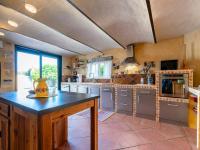 a large kitchen with a large island in the middle at Holiday Home Le Mas d&#39;Adélaïs by Interhome in Baron