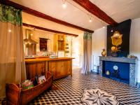 a large kitchen with a table and a counter at Holiday Home Le Mas d&#39;Adélaïs by Interhome in Baron