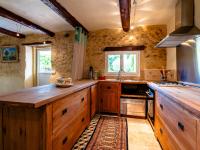 a large kitchen with wooden cabinets and a sink at Holiday Home Le Mas d&#39;Adélaïs by Interhome in Baron