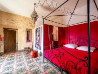 a bedroom with a red bed with a red canopy at Holiday Home Le Mas d&#39;Adélaïs by Interhome in Baron