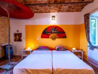 a bedroom with a large bed with yellow walls at Holiday Home Le Mas d&#39;Adélaïs by Interhome in Baron