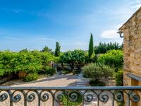 a view of a garden from a balcony at Holiday Home Le Mas d&#39;Adélaïs by Interhome in Baron