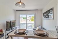 a kitchen with a table with two dishes on it at Appartement Tasdon - Welkeys in La Rochelle