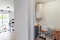 a kitchen with a sink and a toilet in a room at Appartement Tasdon - Welkeys in La Rochelle