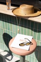 a hat and a table with a sign on it at The Ryder Hotel in Charleston