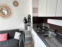 a small kitchen with a sink and a stove at BARCABEACH front de mer avec terrasse et parking in Le Barcarès