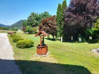 a bird house sitting in the grass near a path at Chalet de Grettery in Saulxures-sur-Moselotte