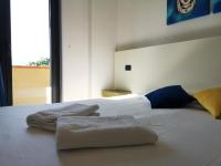 A bed or beds in a room at Oasi Park Hotel