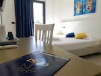 A bed or beds in a room at Oasi Park Hotel