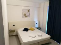 A bed or beds in a room at Oasi Park Hotel