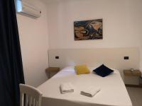 A bed or beds in a room at Oasi Park Hotel