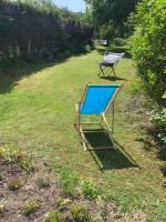 a blue chair sitting on the grass in a yard at Entre mer et falaises in Équihen-Plage