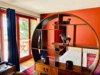 a bedroom with an orange wall with a large mirror at Mazille Les Trois Monts in Mazille