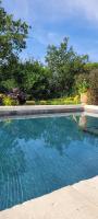 a swimming pool with blue water in a yard at Au milieu des vignes piscine chauffée clim dans maison vigneronne in Mondragon