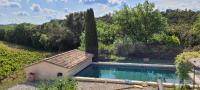 a house with a swimming pool in a garden at Au milieu des vignes piscine chauffée clim dans maison vigneronne in Mondragon