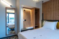 a bedroom with a bed and a door to a balcony at NERO SEASCAPE SUITES in Fanari