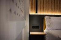 a bedroom with a bed with a yellow head board at NERO SEASCAPE SUITES in Fanari