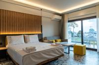 a hotel room with a bed and a large window at NERO SEASCAPE SUITES in Fanari