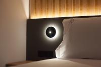 a headboard of a bed with a light on it at NERO SEASCAPE SUITES in Fanari