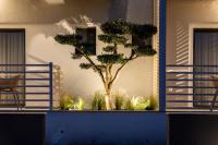 a tree in a planter on the side of a building at NERO SEASCAPE SUITES in Fanari