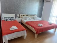 a bedroom with two beds with towels on them at Apartment Gordana in Trogir