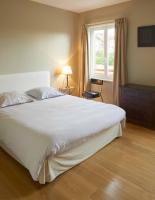 a bedroom with a large white bed and a window at La Maison de Charlotte in Doudeville