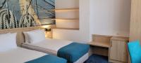 Łóżko lub łóżka w pokoju w obiekcie Hotel Eureka