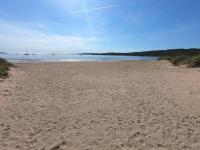 a sandy beach with the ocean in the background at Presqu&#39;ile de Giens - Hameau de la Pinede in Hyères