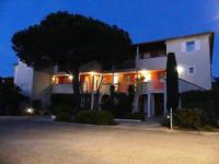 a large white building with a tree in front of it at Presqu&#39;ile de Giens - Hameau de la Pinede in Hyères