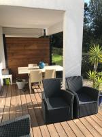 a patio with a table and chairs on a deck at Appartement T2 Manoir de Malville in Nantes
