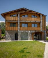 a large wooden house with a balcony at Berg Liptov in Liptovský Mikuláš