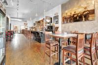 een restaurant met tafels en stoelen en een bar bij Heart & Hops Brewery Suites in Kingsville