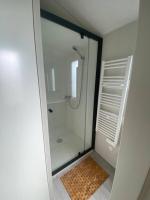 a shower with a glass door in a bathroom at L&#39;arbre perché in Saint-Raphaël