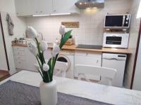 a kitchen with a vase with white flowers in it at Chill Out Cabanon Coeur Calanques in Marseille
