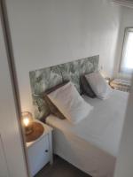 a bedroom with a bed with a headboard and a lamp at Chill Out Cabanon Coeur Calanques in Marseille